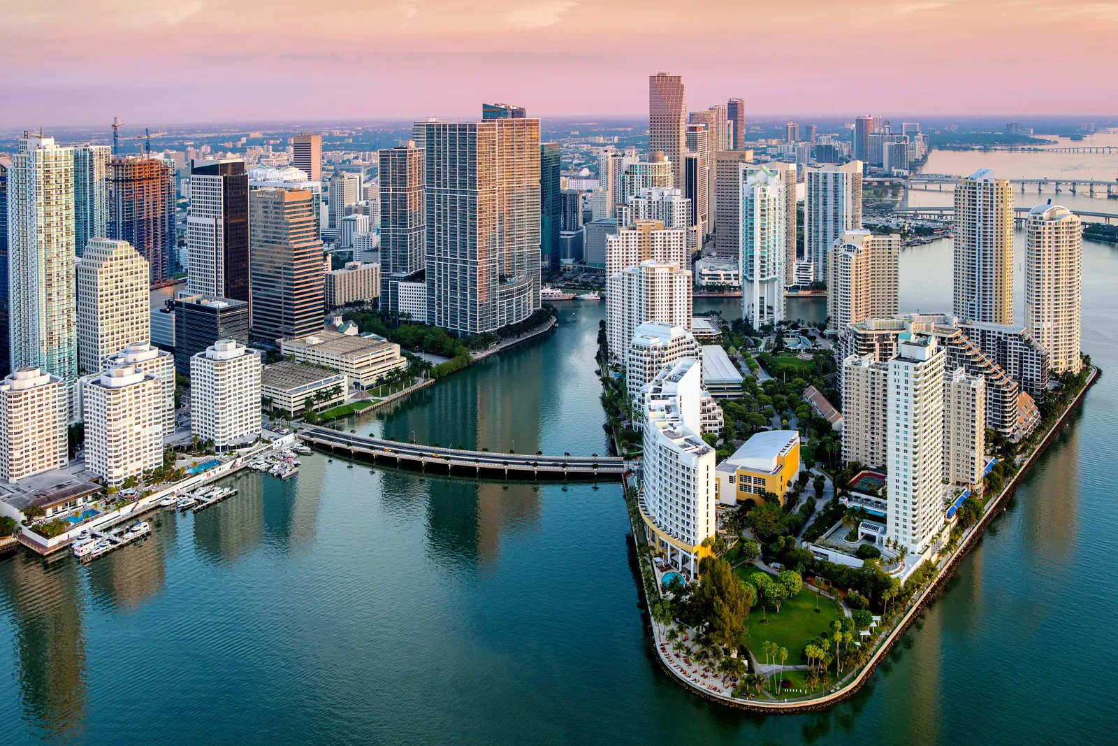 Aerial view of Brickell and Brickell Key at sunset, with towers along the bay and the bridge linking the island to the neighborhood