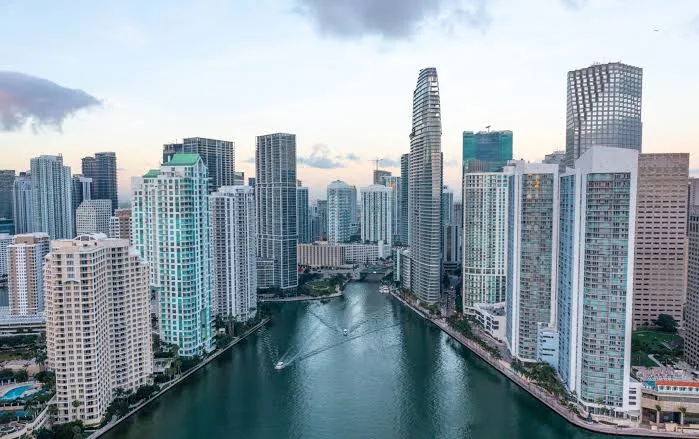 The Miami River between apartment and office towers, with a boat passing