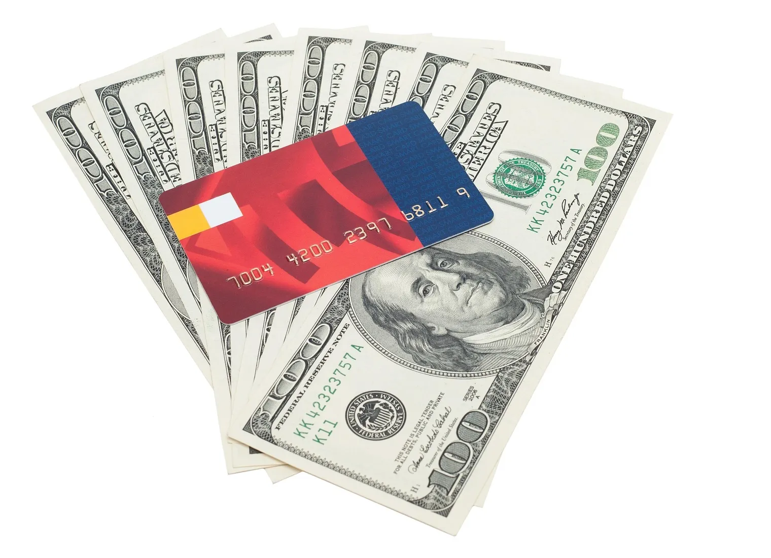 Hundred-dollar bills fanned out with a bank card on top