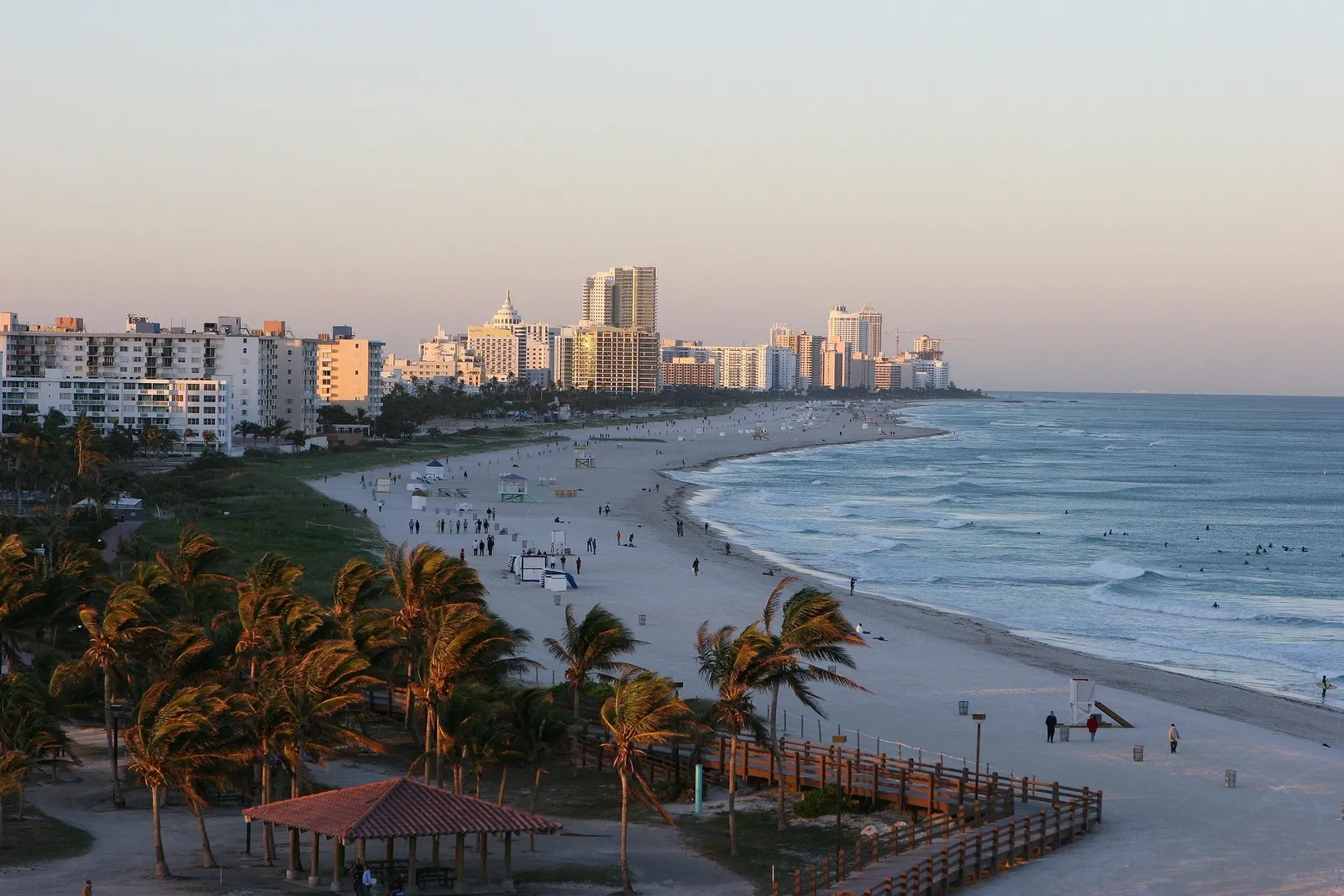 Miami Beach at sunset, with palm trees and oceanfront buildings