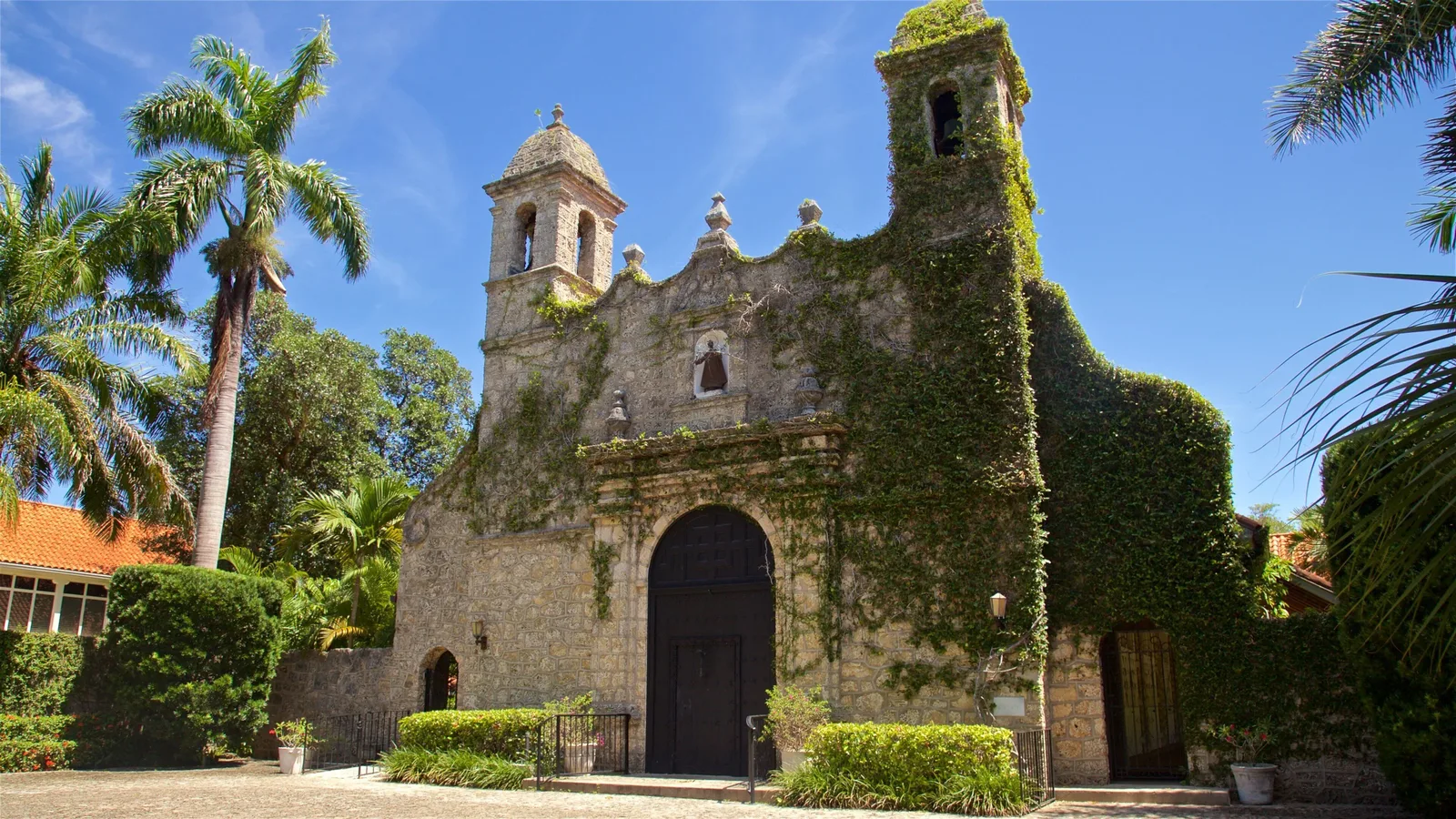 Coconut Grove's Plymouth Congregational Church, an ivy-covered Spanish mission-style stone church among palm trees