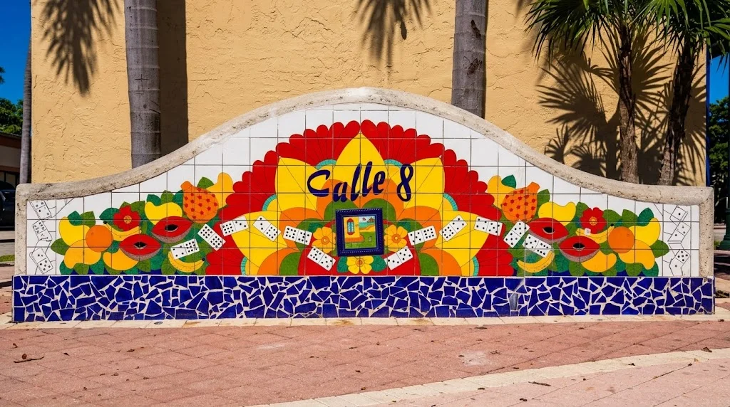 A colorful tile mural reading Calle 8, decorated with tropical fruit and domino tiles