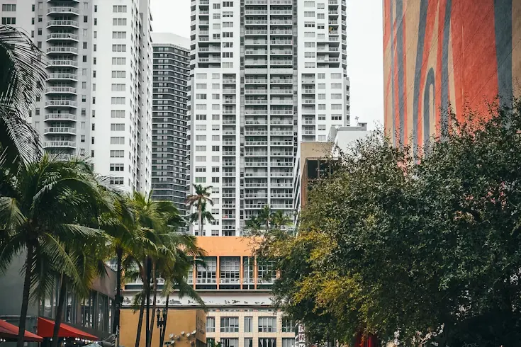 Residential towers in Brickell, Miami, next to a building with a red mural