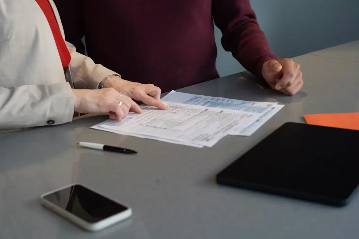 Two people go over forms at a table