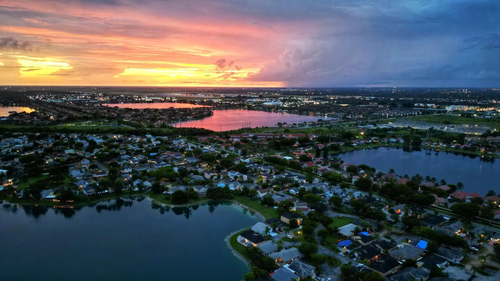 Aerial view at sunset of housing communities beside several lakes in southwest Miami-Dade